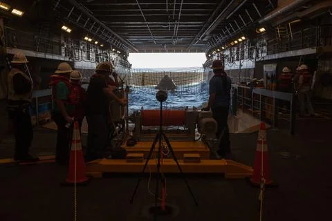 RECORD DATE NOT STATED  Winch team operators help guide a test version of ... Stock Photos