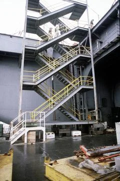 RECORD DATE NOT STATED Workers climb a stairway erected on an elevator abo... Stock Photos