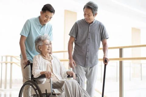 RECORD DATE NOT STATED Young Chinese nurse assistant taking care of senior... Fotos de archivo