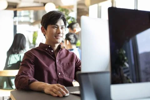 RECORD DATE NOT STATED Young college student using computer Beijing China ... Stock Photos