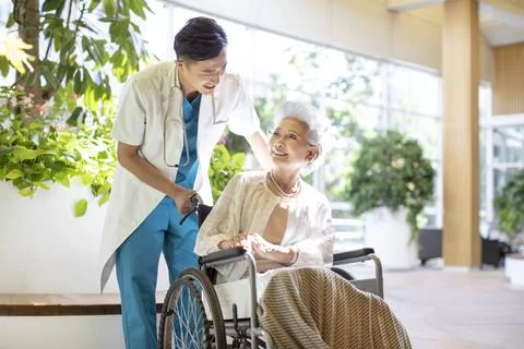 RECORD DATE NOT STATED Young Chinese doctor taking care of senior woman in... 스톡 사진