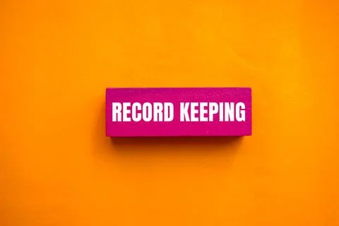 Record keeping message written on pink wooden block with orange background. C Stock Photos