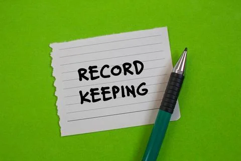 Record keeping message written on ripped torn paper with a pen on green backg Stock Photos