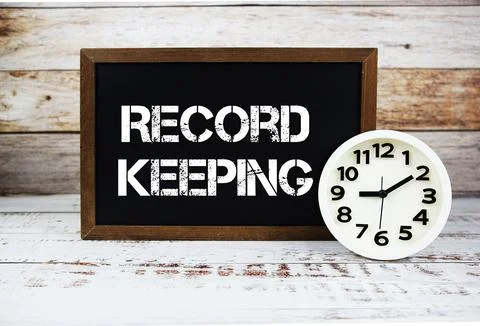Record Keeping text message and alarm clock on wooden background Stock Photos