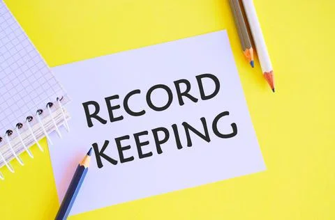 Record keeping text written on a white paper with pencils. Conceptual photo T Stock Photos
