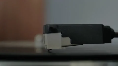 Record needle dropping onto spinning record Stock Footage 169063147