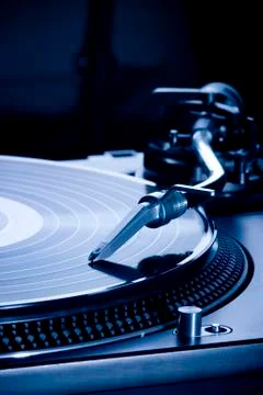 Record player playing LP in dark room, macro picture Stock Photos
