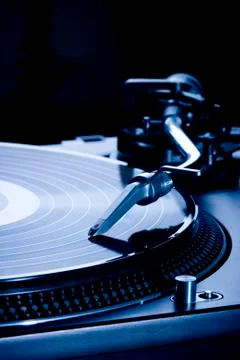 Record player playing LP in dark room, macro picture Stock Photos