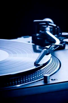 Record player playing LP in dark room, macro picture Stock Photos
