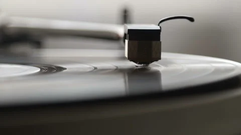 A record player turntable with it's stylus running along a vinyl record Stock Footage 93195683