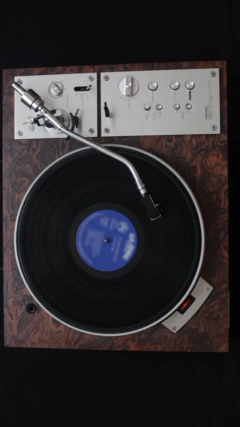 A record player turntable with it's stylus running along a vinyl record. Stock Footage 270357365