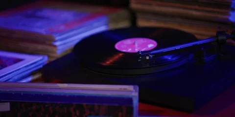 Record playing among a stack of vinyl Stock Footage 113472870