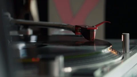 Record playing on a turntable with a chrome arm, red cartridge and target light Stock Footage 127322963