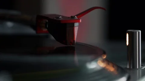 Record playing on a turntable with a chrome arm, red cartridge and target light Stock Footage 127384111