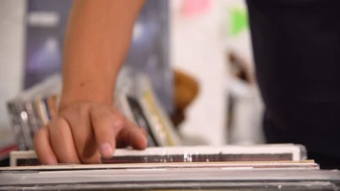 Record store - browsing vinyls Stock Footage 107749171