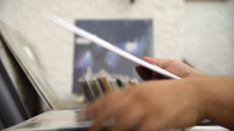 Record store - browsing vinyls Stock Footage 107749417