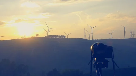 Record video sunset,  Windmill or wind turbine on sunset on mountain golden sky  Stock Footage 95440841