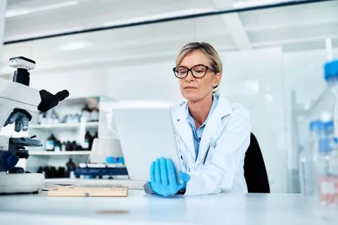 Recording and analysing data at hand. a mature scientist using a digital tablet Stock Photos