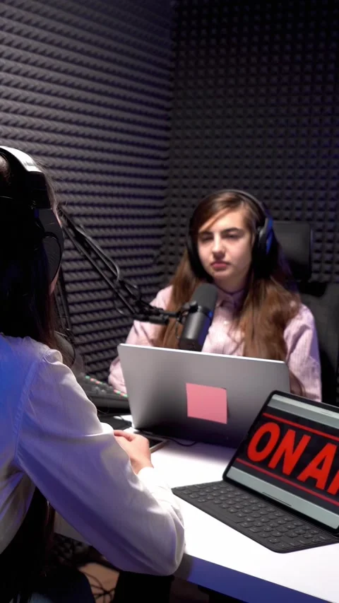 Recording interview podcast in acoustic studio of young female. Vertical video Stock Footage 235437234