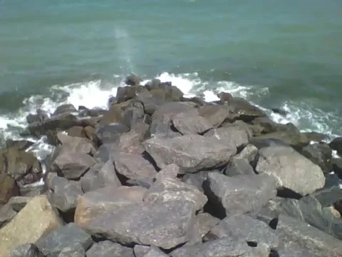 Recording the ocean waves hitting the rocks from the front Stock Footage 163684005