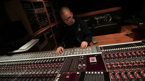 Recording Studio engineer bobbing head mixing music at Console 06 Stock Footage 10774545