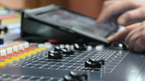 Recording studios audio console and hand pulling up knob. Electronics for amplif Stock Footage 199490170