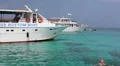 Recreational marine boats with glass bottom are in blue lagoon, Latchi, Cyprus HD Footage