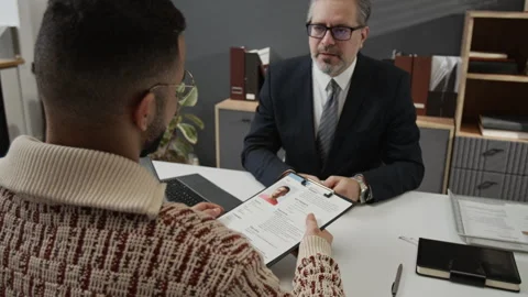 Recruiter Asking Gen Z Candidate to Sign Application Form after Interviewing Him Stock Footage 330518932