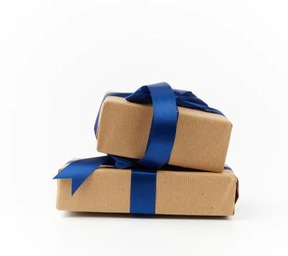Rectangle box wrapped in brown kraft paper and tied with a silk blue ribbon Stock Photos