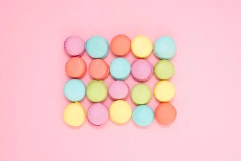 A rectangle of colored macaron on a pink background Stock Photos