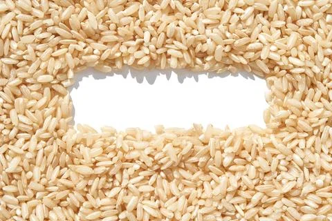 A rectangle frame captures a heap of brown basmati rice on a white background Foto stock