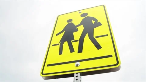 Rectangle pedestrian school zone crossing sign, black print on yellow background Stock Footage 246610594