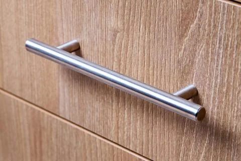 Rectangle shaped kitchen cabinet with stainless steel brushed handles close.. Foto stock