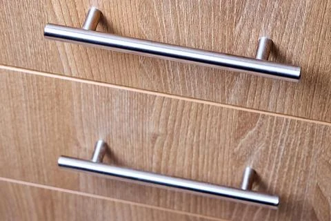 Rectangle shaped kitchen cabinet with stainless steel brushed handles close u 스톡 사진