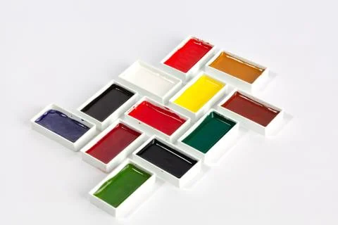 Rectangle solid watercolor pans in creative arrangement on white background Stock Photos