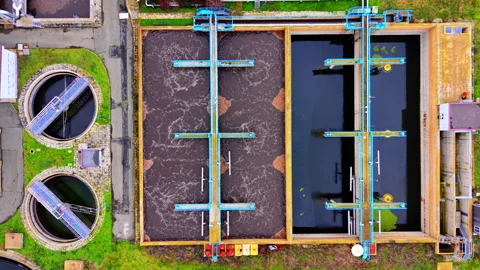 Rectangular and circular tanks at a large wastewater treatment site, Bulgaria Stock Footage 346388704
