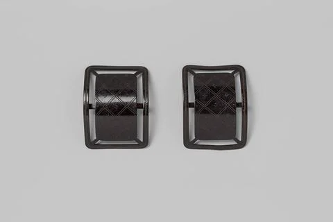 Rectangular and curved shoe buckle of black lacquered metal, with an engra... Stock Photos