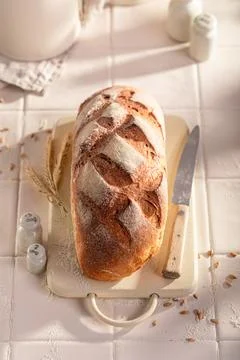 Rectangular and hot loaf of rye bread baked in kitchen. 스톡 사진