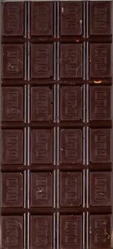 Rectangular bar of dark natural chocolate divided into equal slices 스톡 사진
