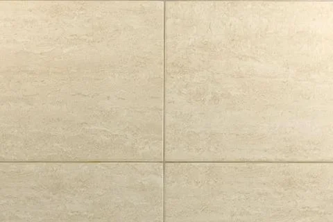 Rectangular beige tiles on the wall. Background or texture. Foto stock