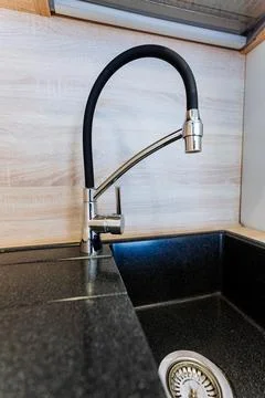 Rectangular black kitchen sink with faucet and drain Foto stock