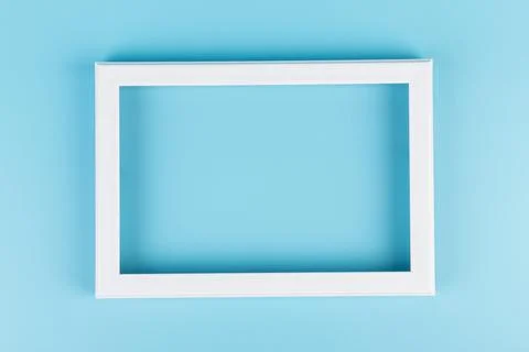 Rectangular blank white picture frame on the blue  background. mockup Foto stock