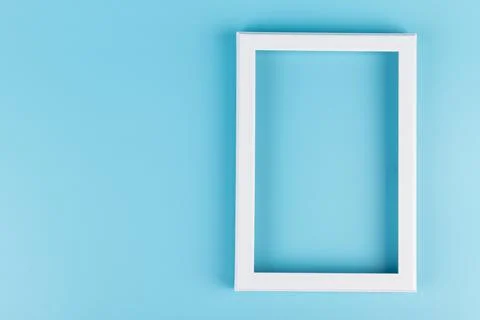 Rectangular blank white picture frame on the blue  background. mockup Stock Photos