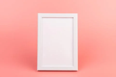 Rectangular blank white picture frame on the pink background. mockup Stock Photos