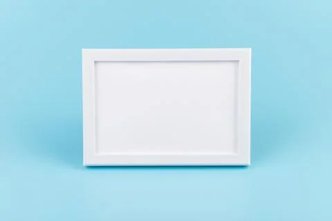 Rectangular blank white picture frame on the blue  background. mockup Foto stock