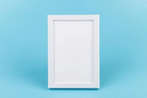 Rectangular blank white picture frame on the blue  background. mockup Stock Photos