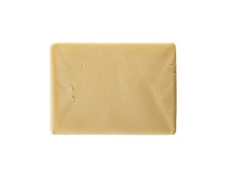 A rectangular block of fresh, creamy butter with a smooth texture and a pale Stock Photos