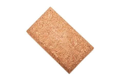 A rectangular block of natural cork is displayed against a white background.  Stock Photos