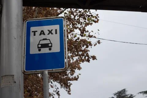 Rectangular blue road sign of taxi parking. Black icon car, text Stock Photos