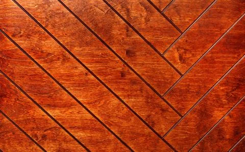 Rectangular boards are painted in orange and neatly laid out with a herringbo Foto stock